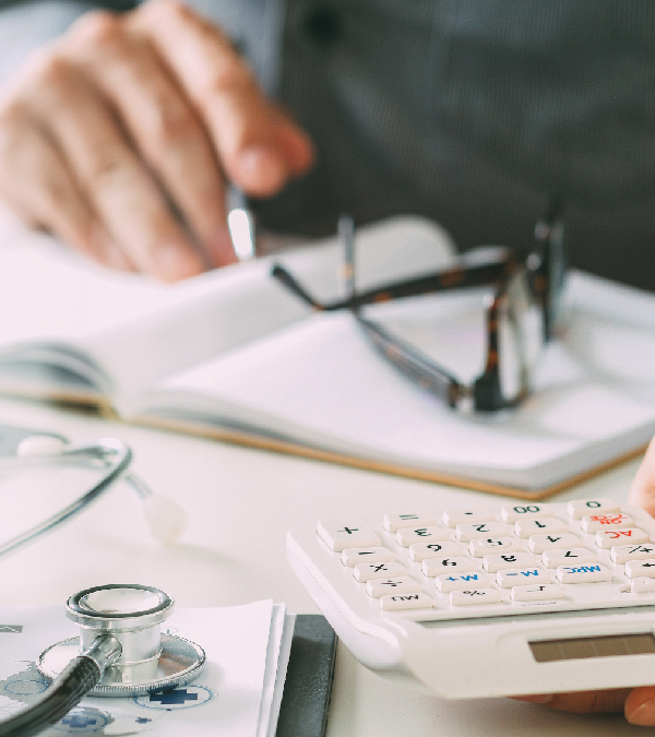 Person working with calculator and notepad